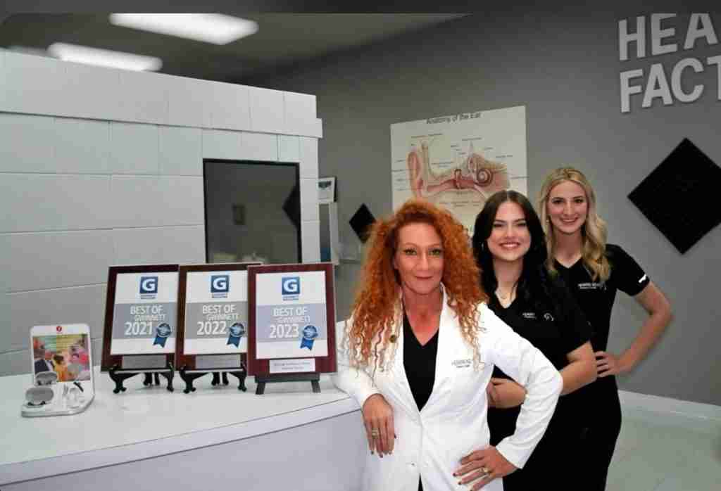 Gwen Cantrell and the Hearing Aid Factory Outlet team with Best of Gwinnett awards inside their Lawrenceville clinic.